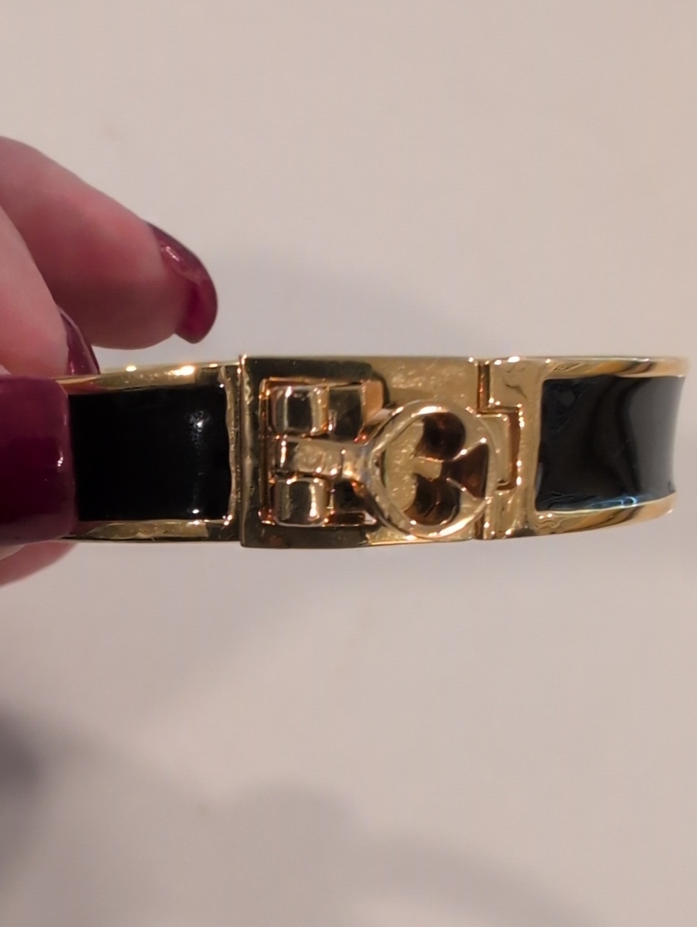 Kate Spade Gold-Tone Bangle Bracelet with Black Enamel.